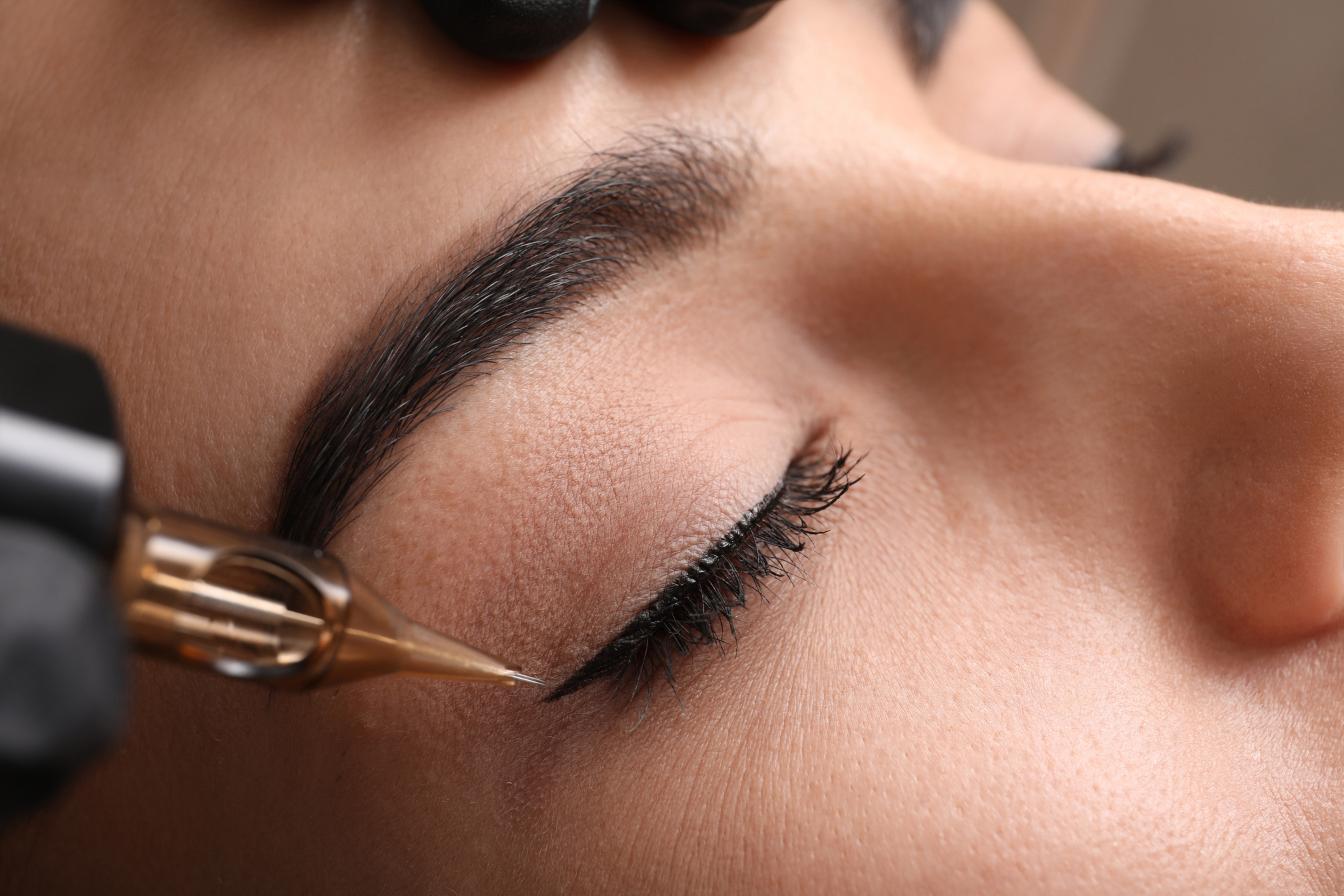 Young Woman Undergoing Procedure of Permanent Eye Makeup in Tatt
